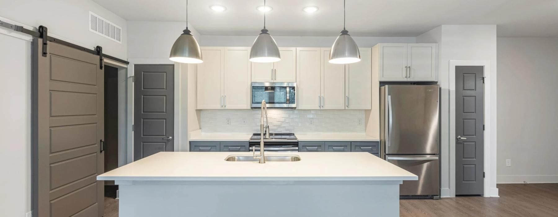 a kitchen with white cabinets