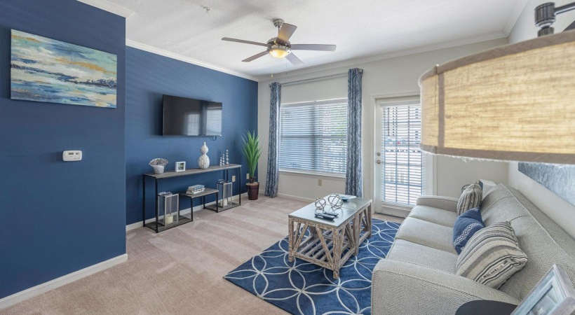 a living room with a couch and a fan