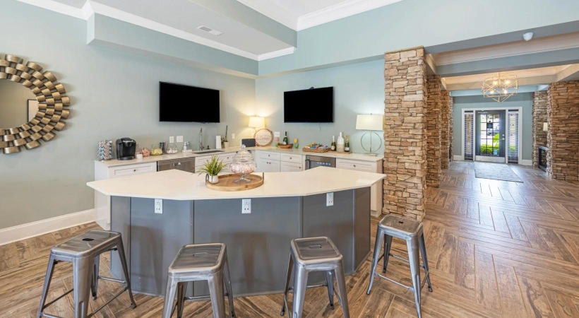 a kitchen with a bar and stools