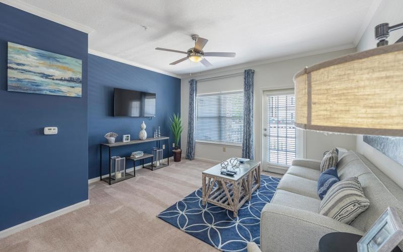 a living room with a couch and a fan
